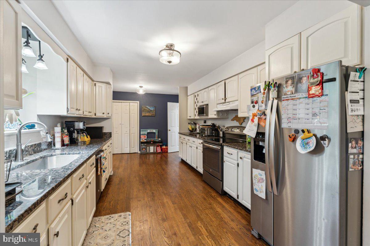5222 Ferndale Street Springfield, VA 22151 - Photo 8 of 33 a kitchen with stainless steel appliances granite countertop a refrigerator a stove top oven a sink and dishwasher