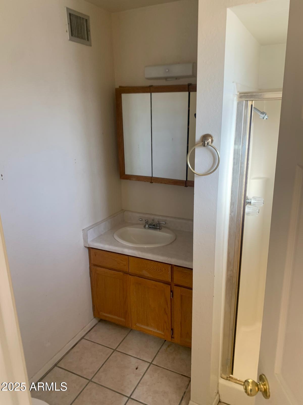 2419 East 10th Street Douglas, AZ 85607 - Photo 12 of 14 a bathroom with a sink and a mirror