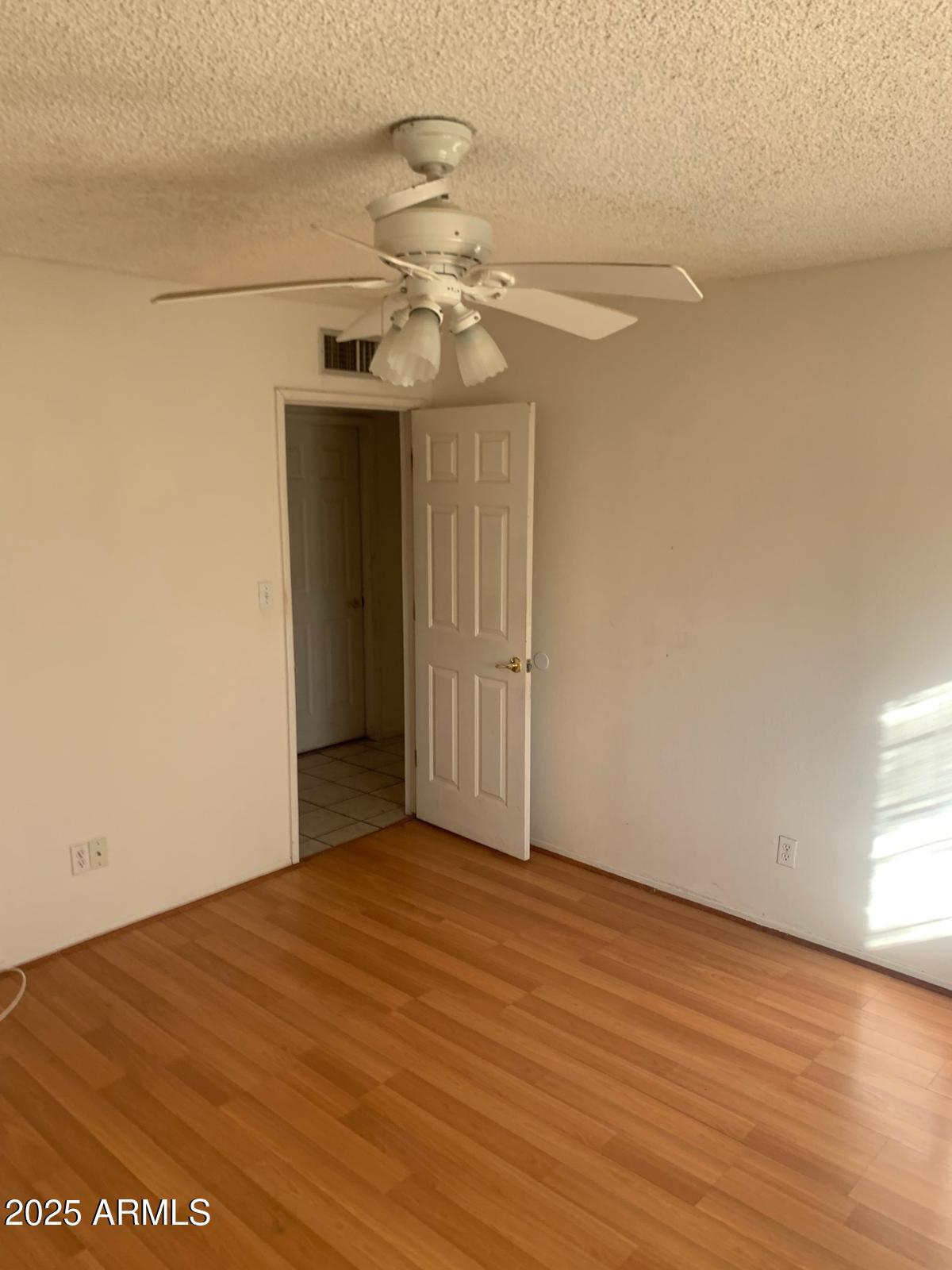 2419 East 10th Street Douglas, AZ 85607 - Photo 10 of 14 wooden floor in an empty room with a window