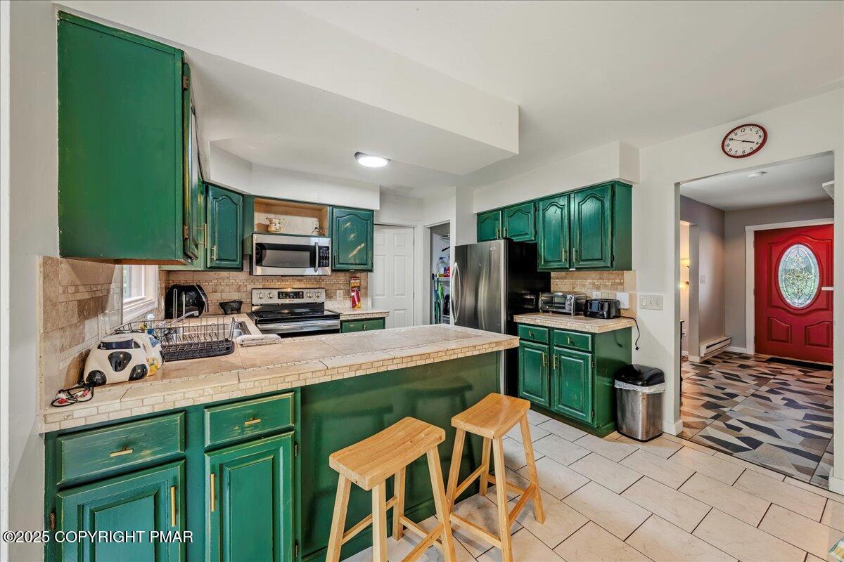 2102 Woodland Court Pocono Summit, PA 18346 - Photo 15 of 42 a kitchen with a sink cabinets and stainless steel appliances