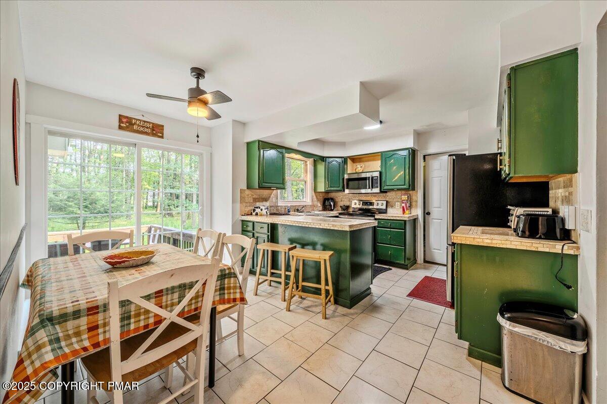 2102 Woodland Court Pocono Summit, PA 18346 - Photo 17 of 42 a dining room with furniture and a window