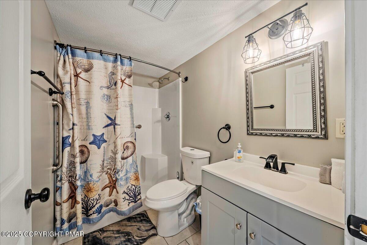 2102 Woodland Court Pocono Summit, PA 18346 - Photo 19 of 42 a bathroom with a sink toilet and shower