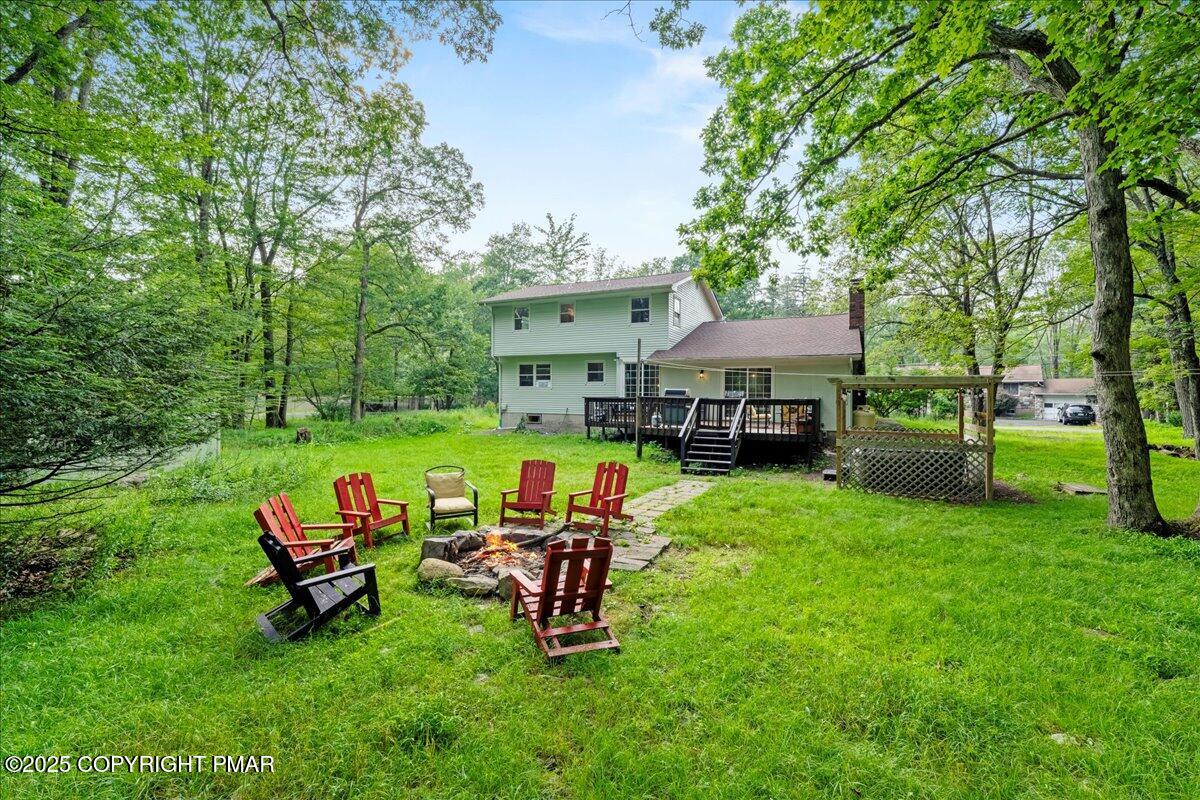 2102 Woodland Court Pocono Summit, PA 18346 - Photo 2 of 42 a view of a house with backyard sitting area and garden