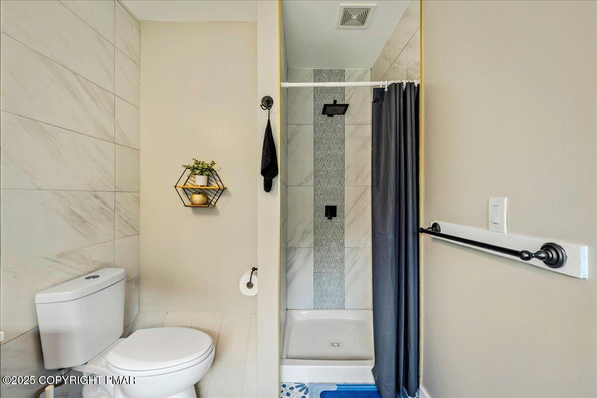 2102 Woodland Court Pocono Summit, PA 18346 - Photo 24 of 42 a white toilet sitting next to a bathroom sink