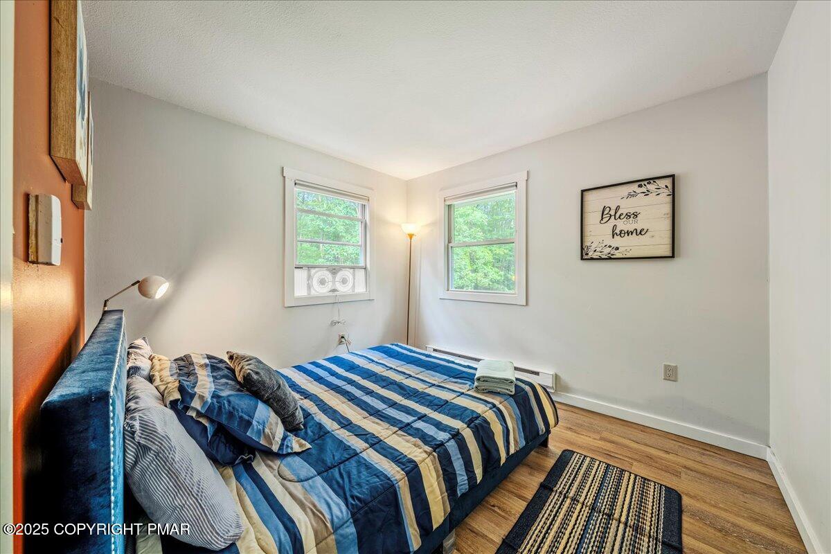 2102 Woodland Court Pocono Summit, PA 18346 - Photo 25 of 42 a bedroom with bed and wooden floor