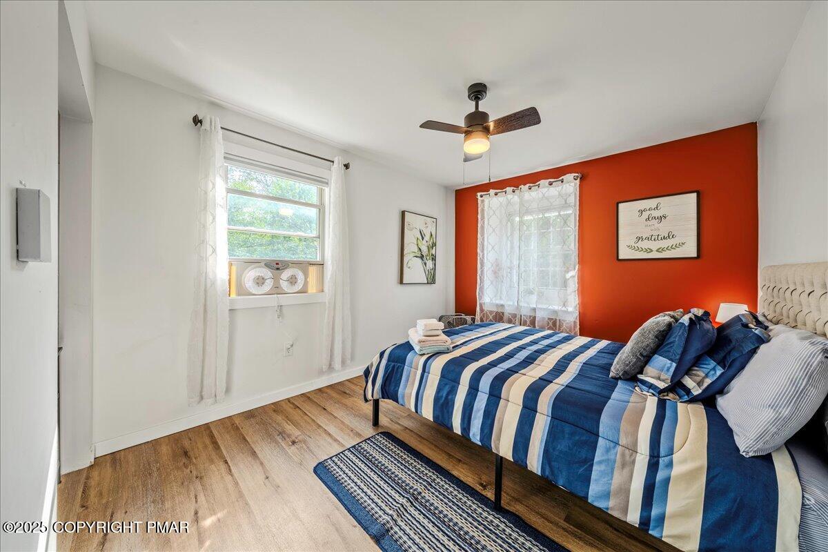 2102 Woodland Court Pocono Summit, PA 18346 - Photo 29 of 42 a bedroom with a bed and wooden floor