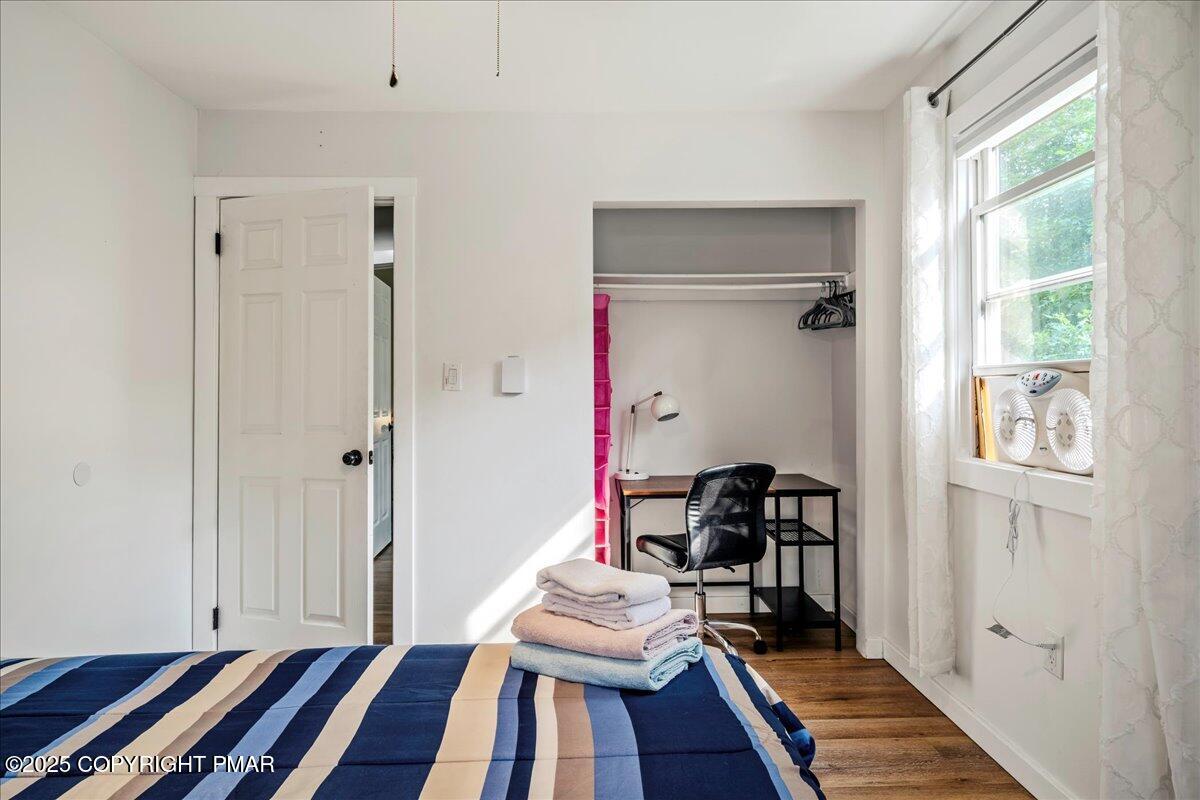 2102 Woodland Court Pocono Summit, PA 18346 - Photo 30 of 42 a bedroom with a bed and wooden floor