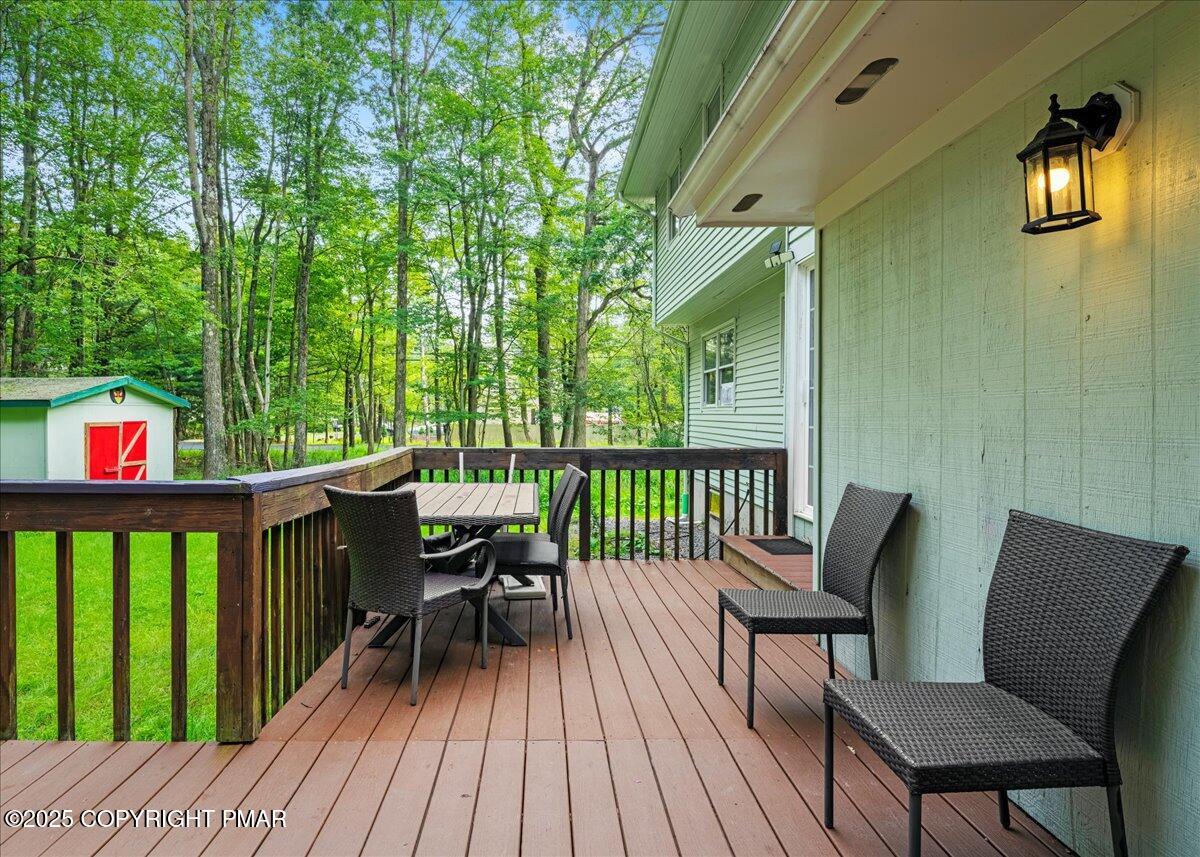 2102 Woodland Court Pocono Summit, PA 18346 - Photo 36 of 42 a view of a deck with two chair and wooden floor