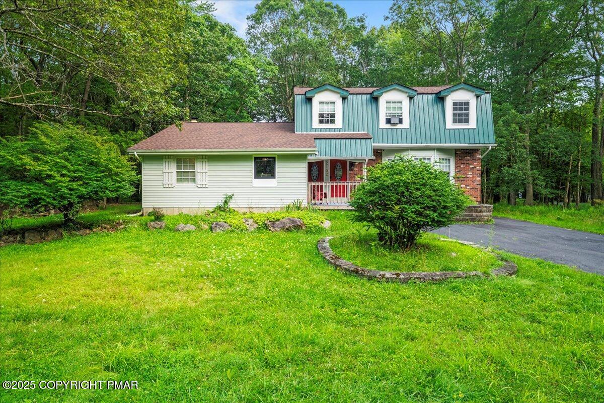 2102 Woodland Court Pocono Summit, PA 18346 - Photo 42 of 42 a front view of a house with a yard and trees