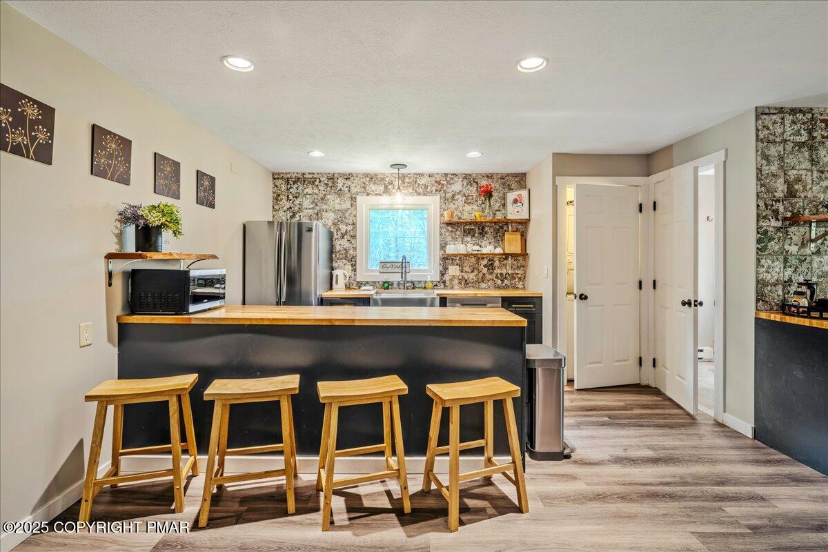 2102 Woodland Court Pocono Summit, PA 18346 - Photo 5 of 42 a living room with a table chairs and a flat screen tv