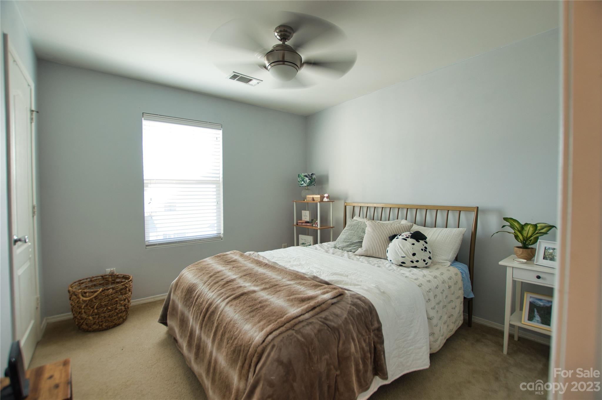 303 River Clay Road, Unit 135 Fort Mill, SC 29708 - Photo 11 of 19 a bedroom with a bed and a chandelier