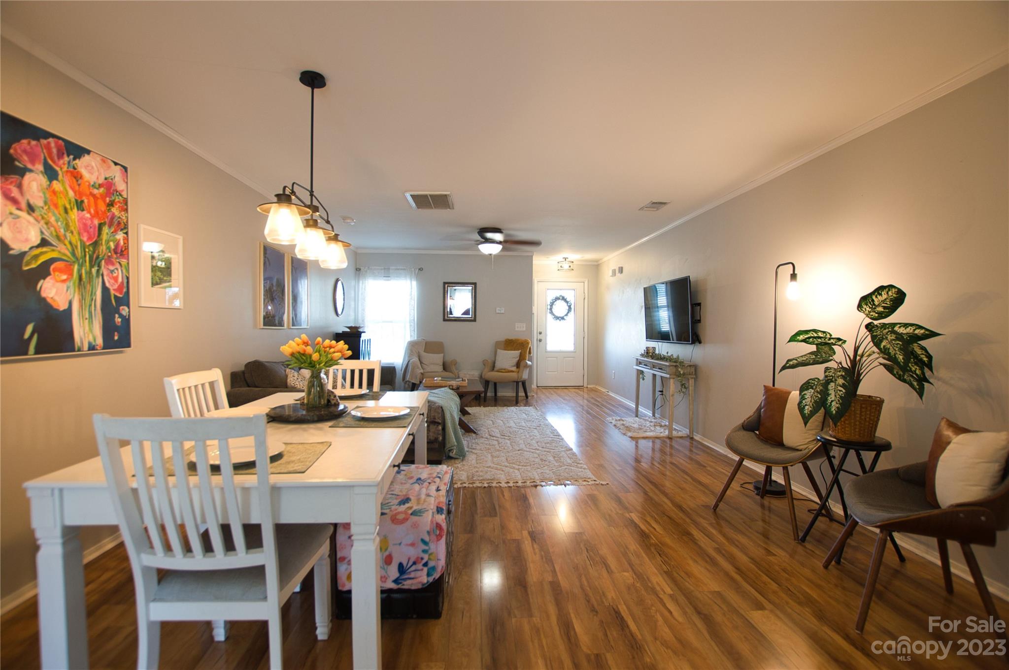 303 River Clay Road, Unit 135 Fort Mill, SC 29708 - Photo 7 of 19 a view of a dining room and livingroom with furniture wooden floor a rug a painting and a chandelier