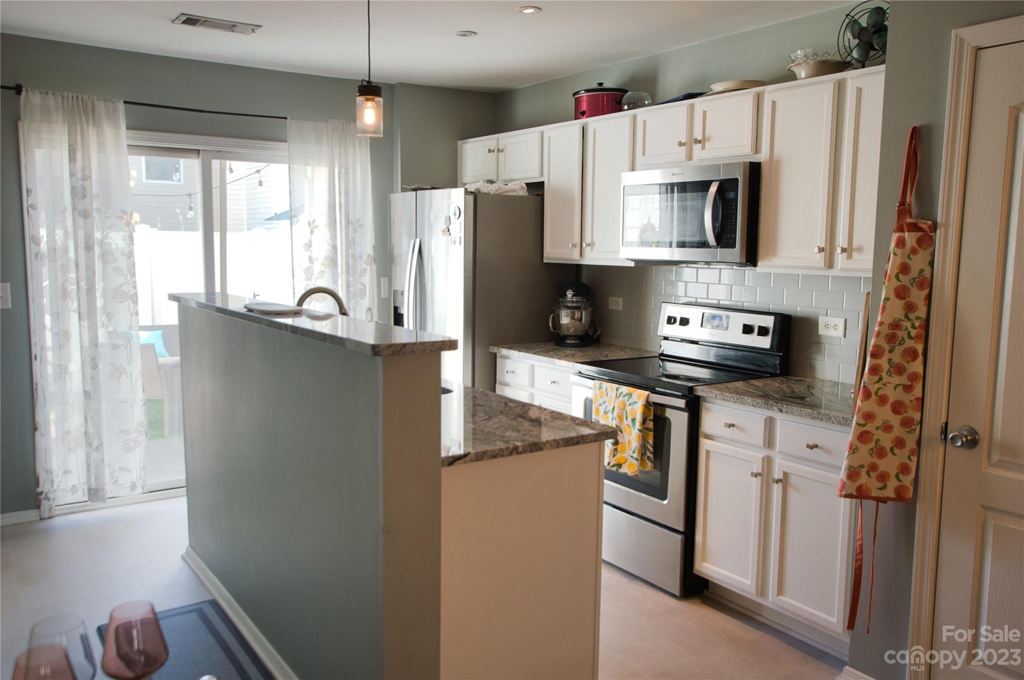 303 River Clay Road, Unit 135 Fort Mill, SC 29708 - Photo 9 of 19 a kitchen with stainless steel appliances a refrigerator sink and microwave