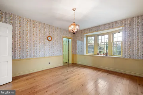 a kitchen with a sink cabinets stainless steel appliances and a window