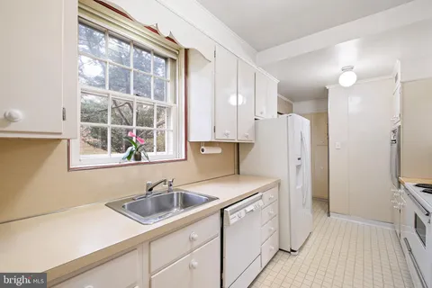 a kitchen with stainless steel appliances granite countertop a stove and a refrigerator