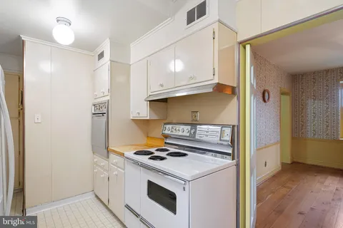 a utility room with cabinets washer and dryer