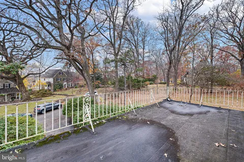 a bathroom with a sink a toilet a window and shower