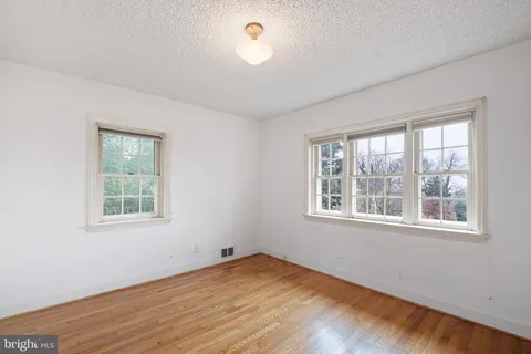 a spacious bedroom with a bed and a table in it