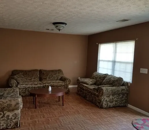 a living room with furniture and a window
