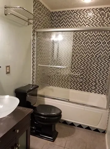 a living room with furniture and a fan