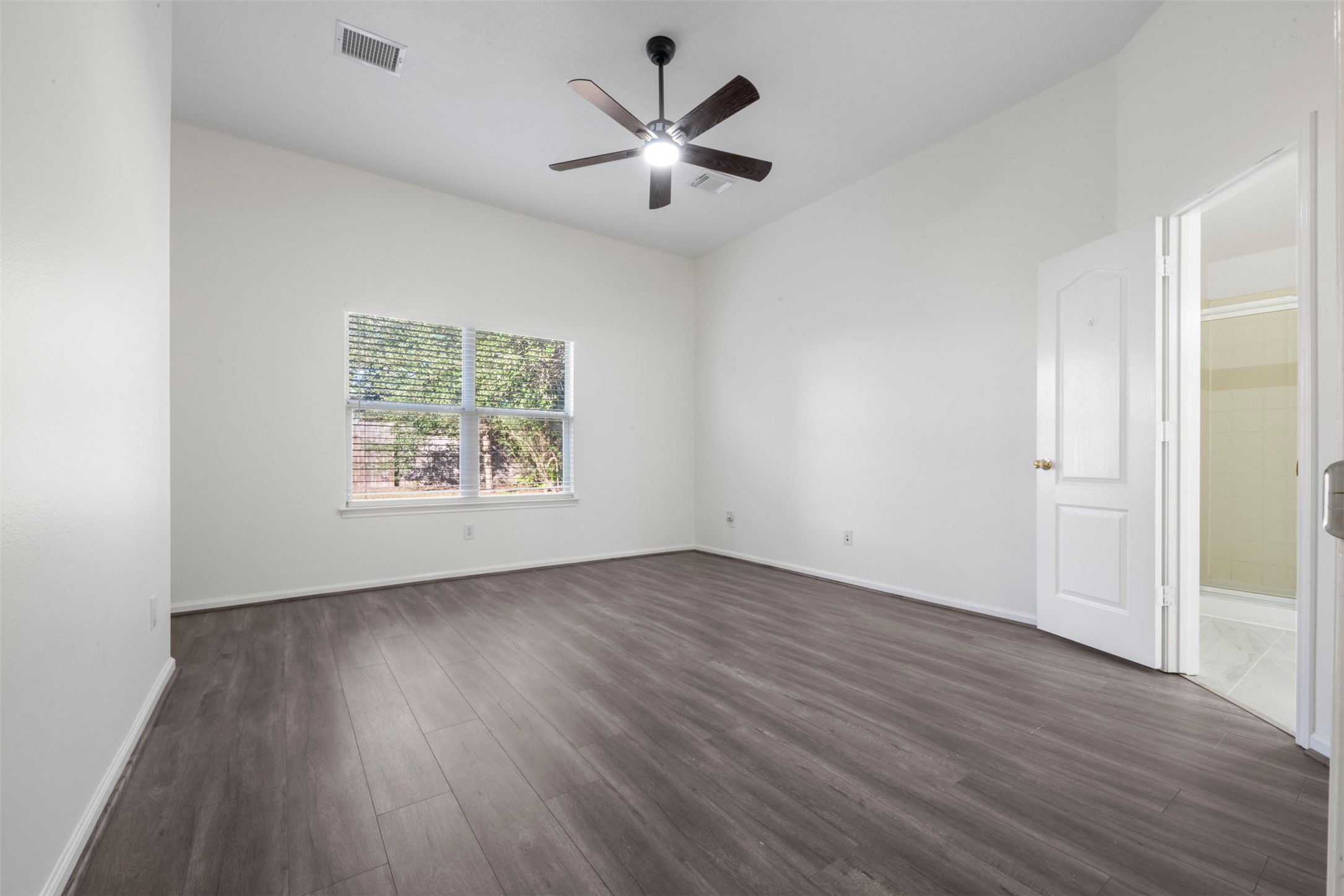 3507 Palomar Valley Drive Spring, TX 77386 - Photo 17 of 22 an empty room with wooden floor and windows
