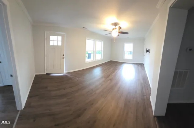 wooden floor in an empty room with a window