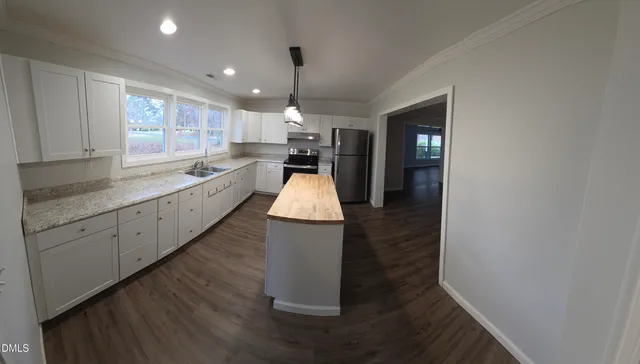 a large kitchen with sink and cabinets
