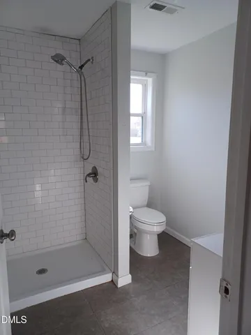 a bathroom with a toilet and shower