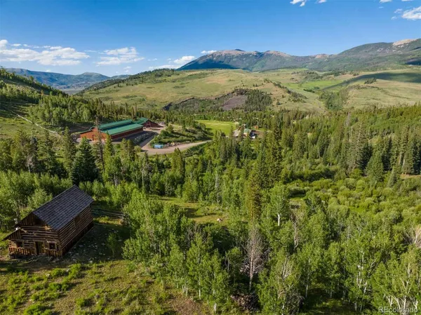 a view of a lush green hillside and houses