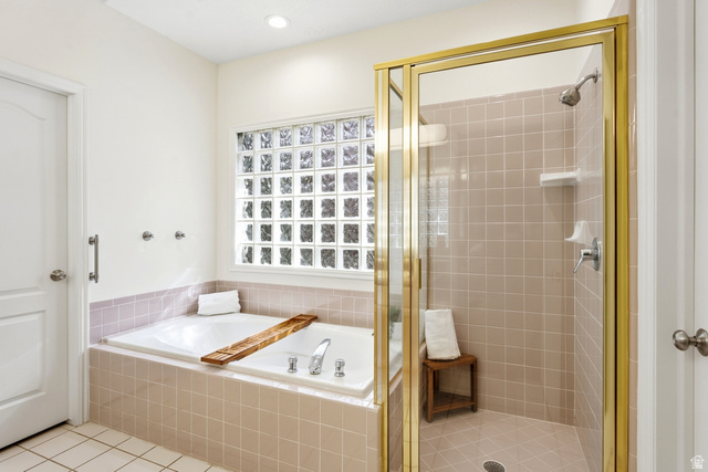 1462 Rio Grande Road Park City, UT 84098 - Photo 16 of 30 Recessed lighting, glass block window, built-in soaking tub, tile flooring, and a glass-enclosed shower with a gold-tone frame