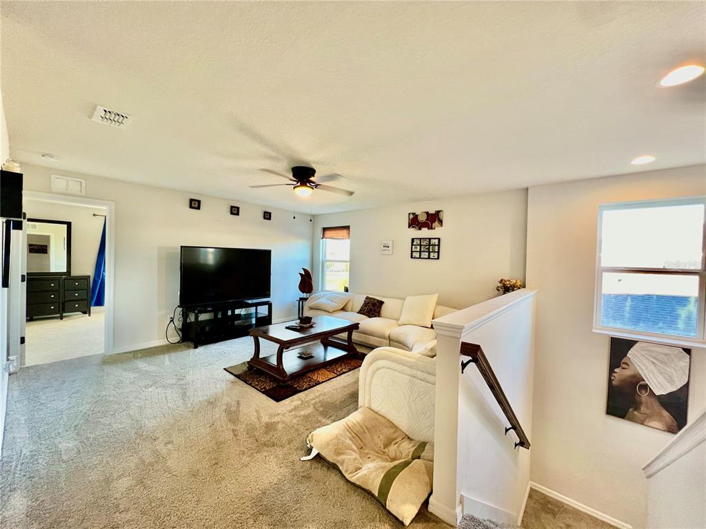 14112 Poke Ridge Drive Riverview, FL 33579 - Photo 14 of 46 a living room with furniture and a flat screen tv