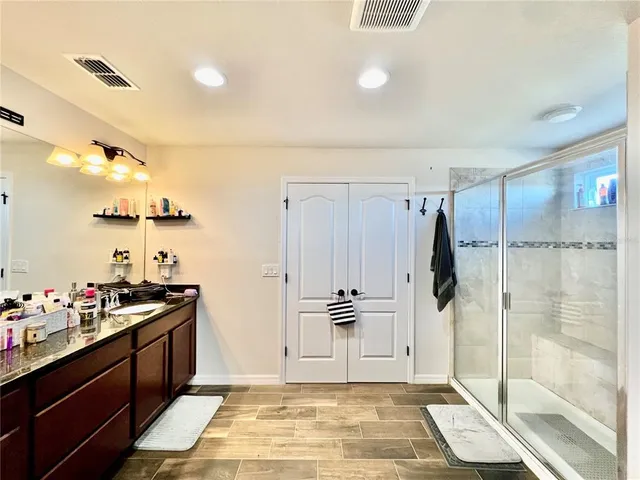 a bathroom with a shower and a sink