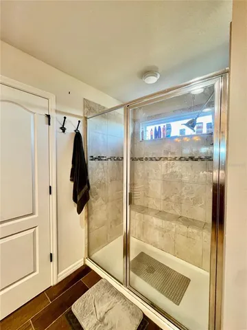 a bathroom with a shower and a glass door