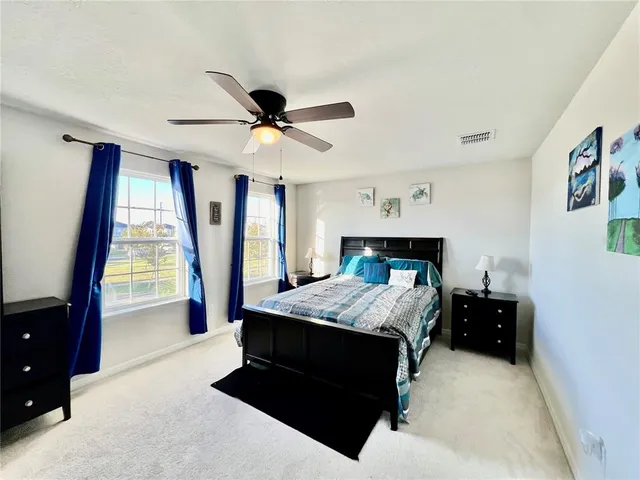 a bedroom with a bed and a large window