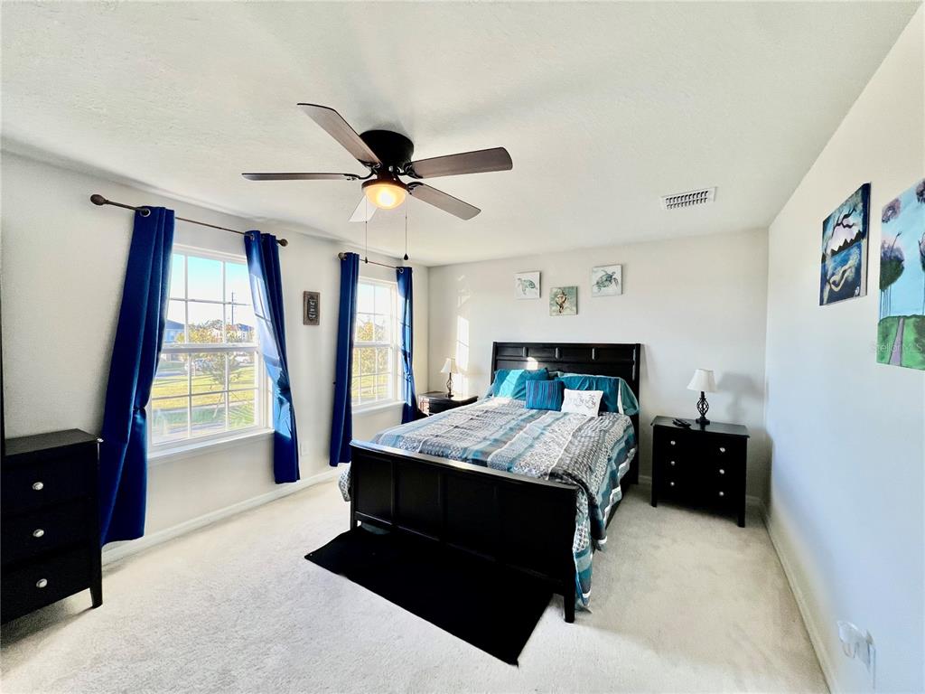 14112 Poke Ridge Drive Riverview, FL 33579 - Photo 25 of 46 a bedroom with a bed and a large window