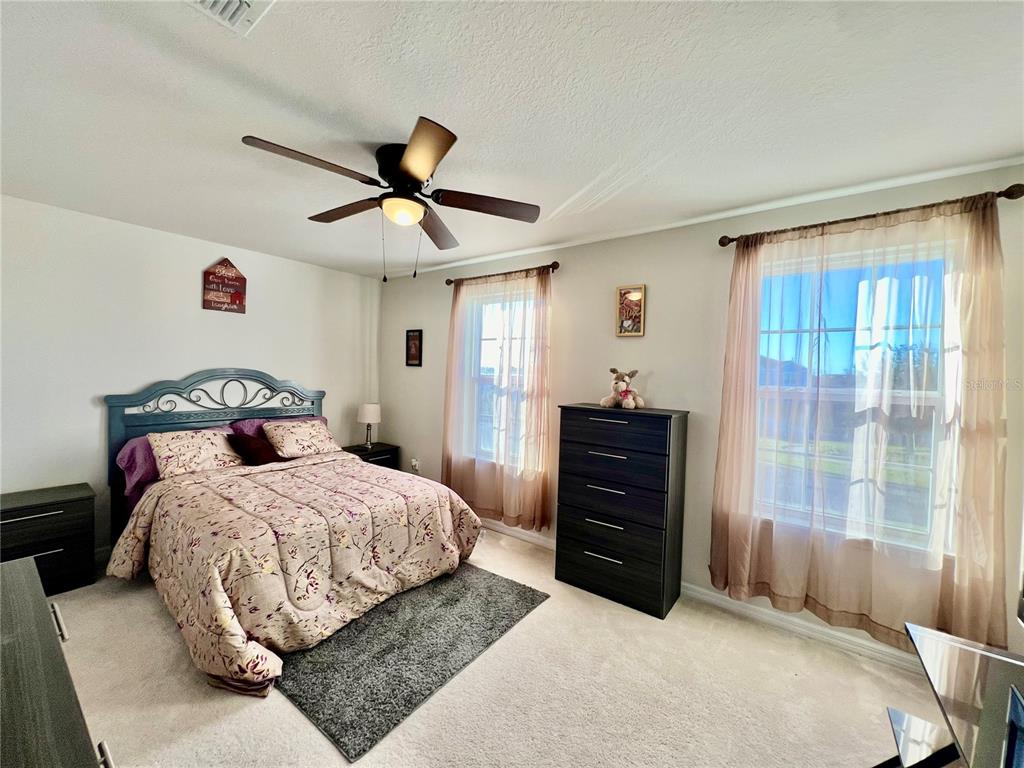 14112 Poke Ridge Drive Riverview, FL 33579 - Photo 26 of 46 a bedroom with a bed and a dresser