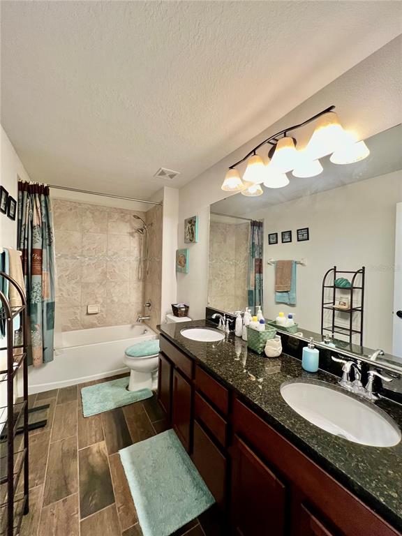 14112 Poke Ridge Drive Riverview, FL 33579 - Photo 28 of 46 a bathroom with a granite countertop sink mirror and a bathtub