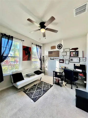 a living room with furniture windows and a flat screen tv
