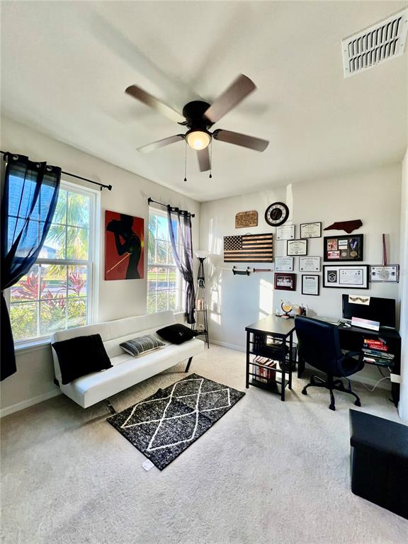 14112 Poke Ridge Drive Riverview, FL 33579 - Photo 30 of 46 a living room with furniture windows and a flat screen tv