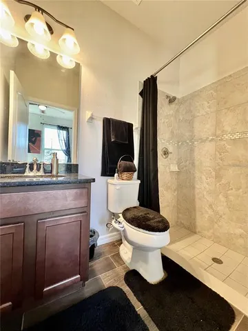 a bathroom with a sink toilet and shower