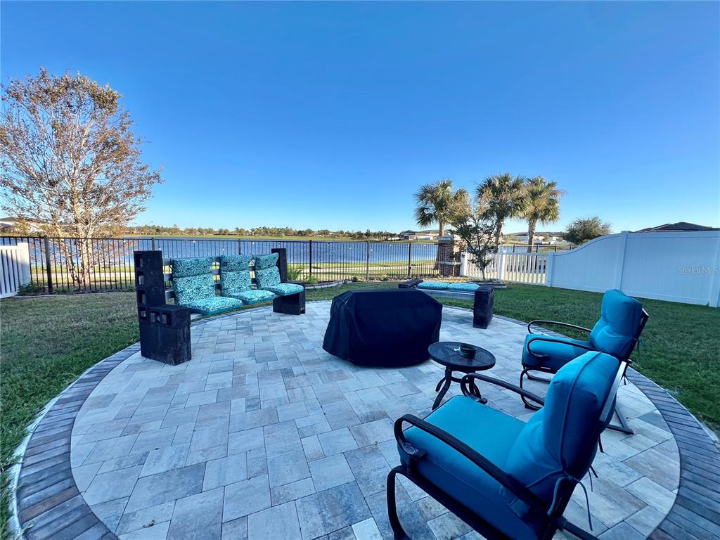14112 Poke Ridge Drive Riverview, FL 33579 - Photo 35 of 46 a view of a patio with couches chairs potted plants and a big yard