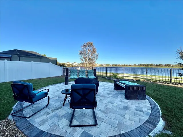 a roof deck with table and chairs couches under an umbrella