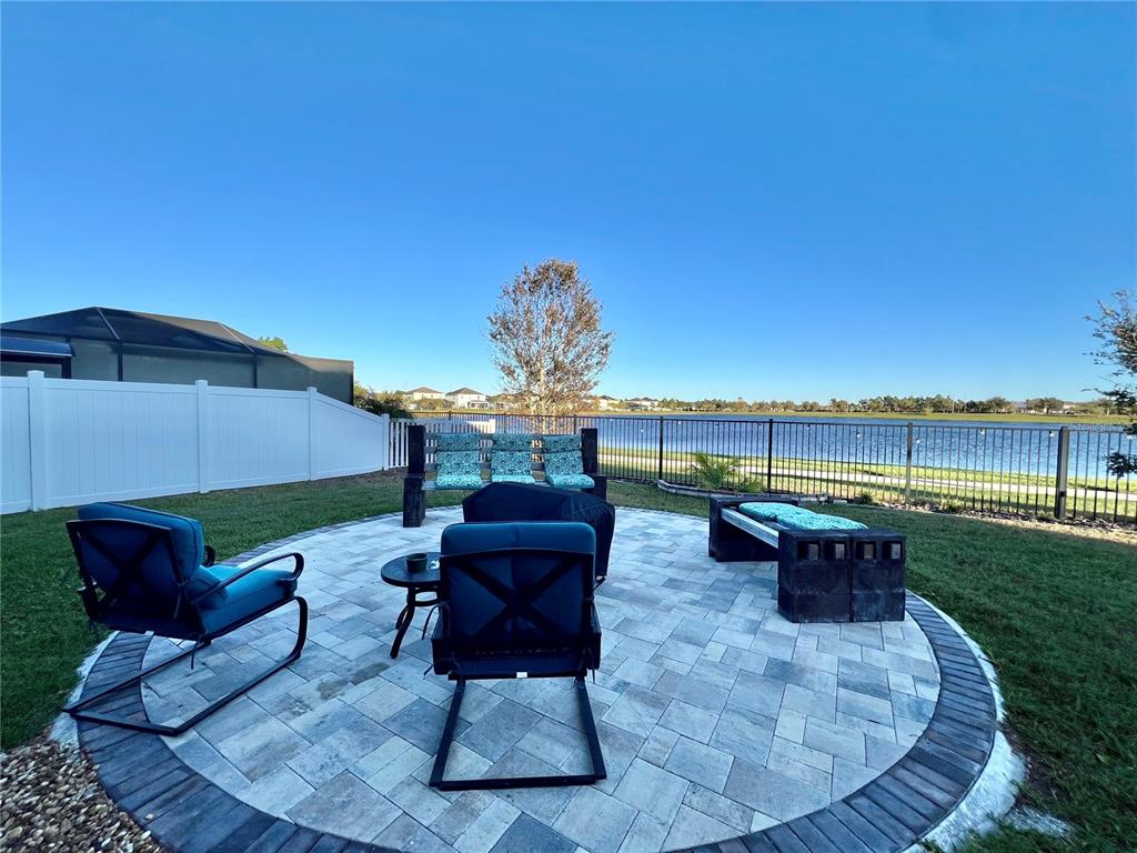 14112 Poke Ridge Drive Riverview, FL 33579 - Photo 36 of 46 a roof deck with table and chairs couches under an umbrella