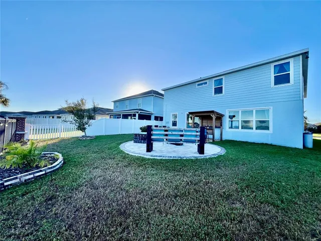 a view of a house with backyard sitting area and garden