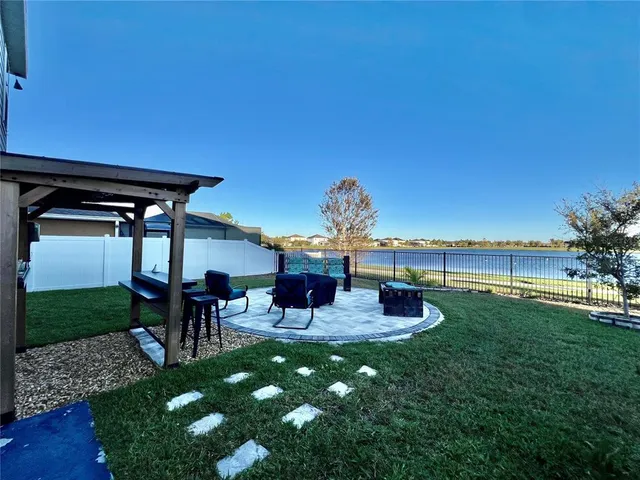 a view of a house with backyard porch and sitting area