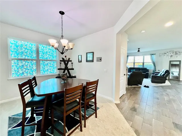 a view of a dining room with furniture and window