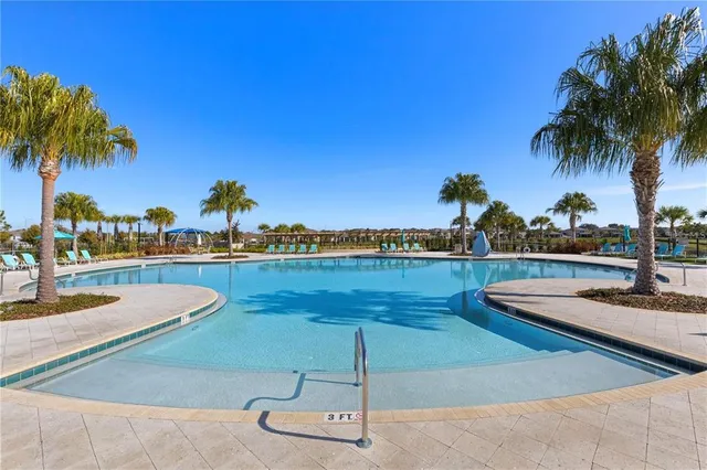 a view of swimming pool with seating area