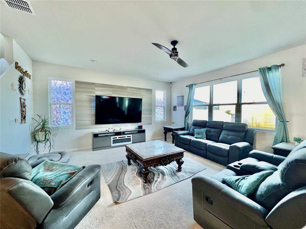 14112 Poke Ridge Drive Riverview, FL 33579 - Photo 5 of 46 a living room with furniture and a flat screen tv