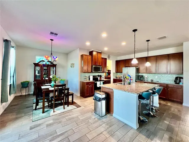 a large kitchen with a table and chairs