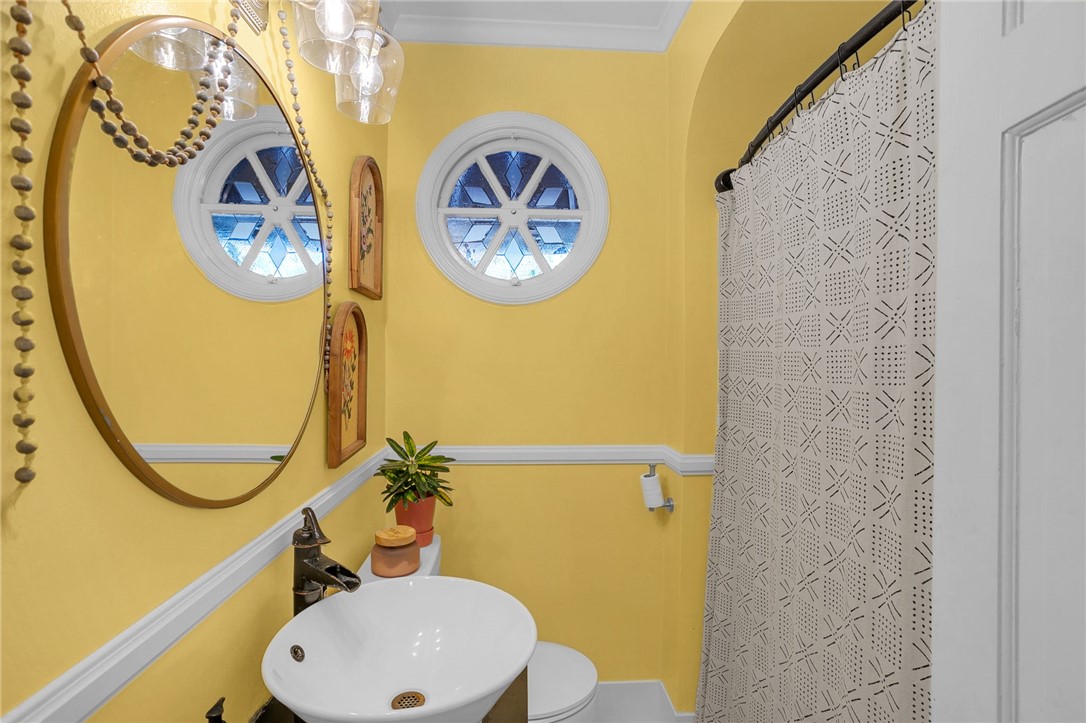 1107 Springdale Road Anderson, SC 29621 - Photo 19 of 49 This bright bathroom features unique round windows and a classic white vanity.